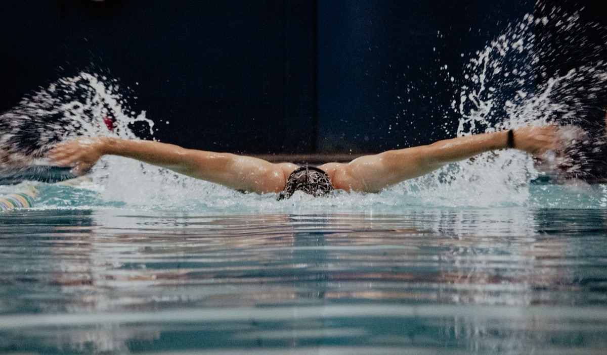 View of legs kicking during freestyle swimming